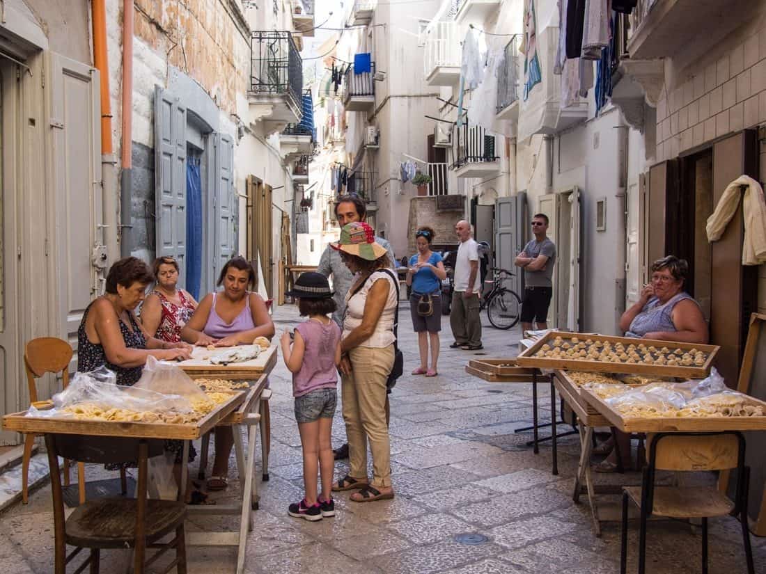 Women making orecchiette pasta on the streets of Bari, Puglia, Italy
