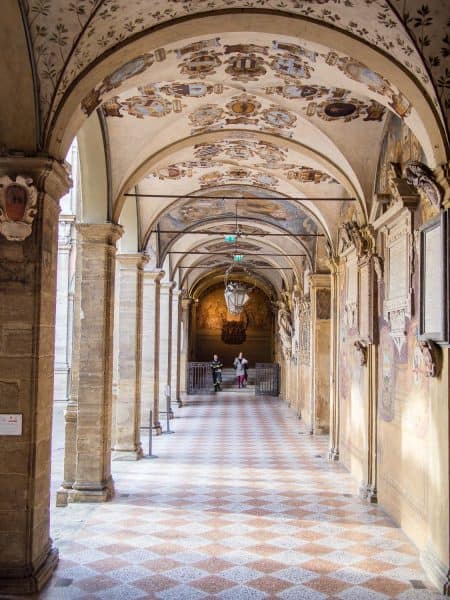 The gorgeous fresco covered porticos in the courtyard of the Archiginasio, Bologna University, Italy