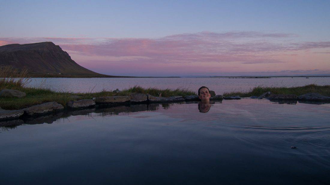 Enjoying an Icelandic hot pot at sunset at Birkimelur Swimming Pool in the Westfjords.