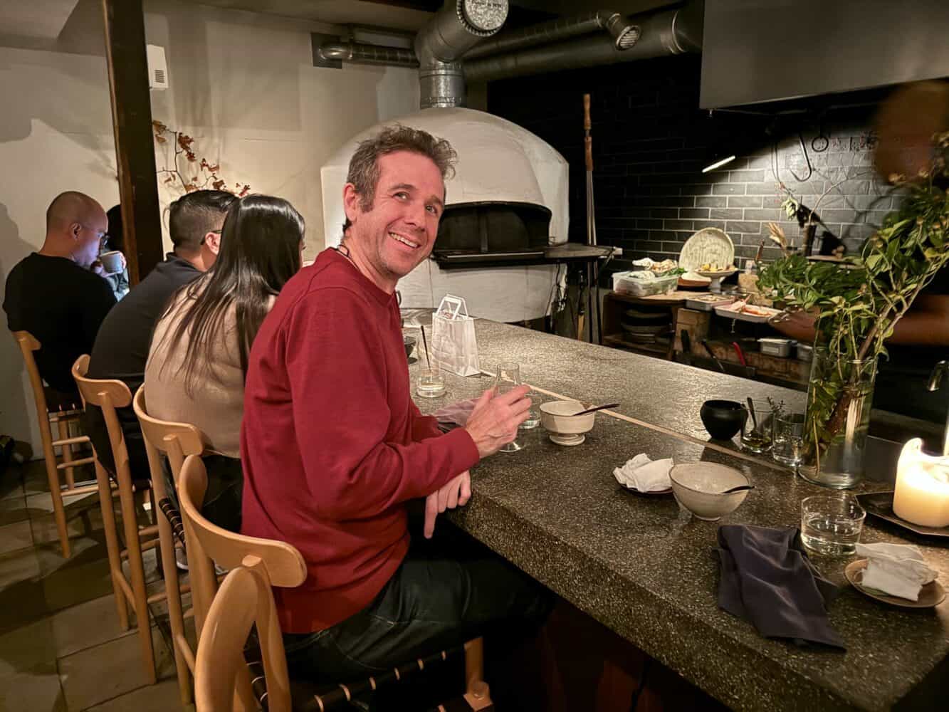 Simon sat at the counter in Monk Restaurant, Kyoto, Japan