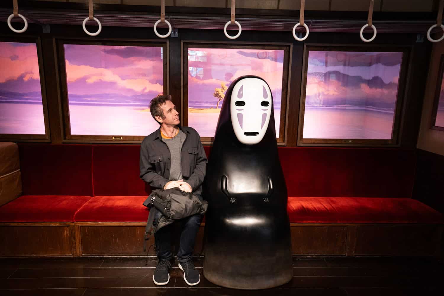 Simon sitting next to No Face from Spirited Away, Ghibli Park, Japan
