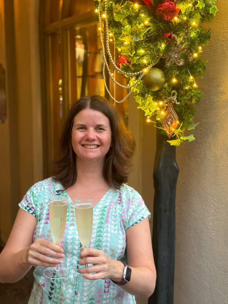 Erin with glasses of champagne in the France pavilion of Epcot, Disney World