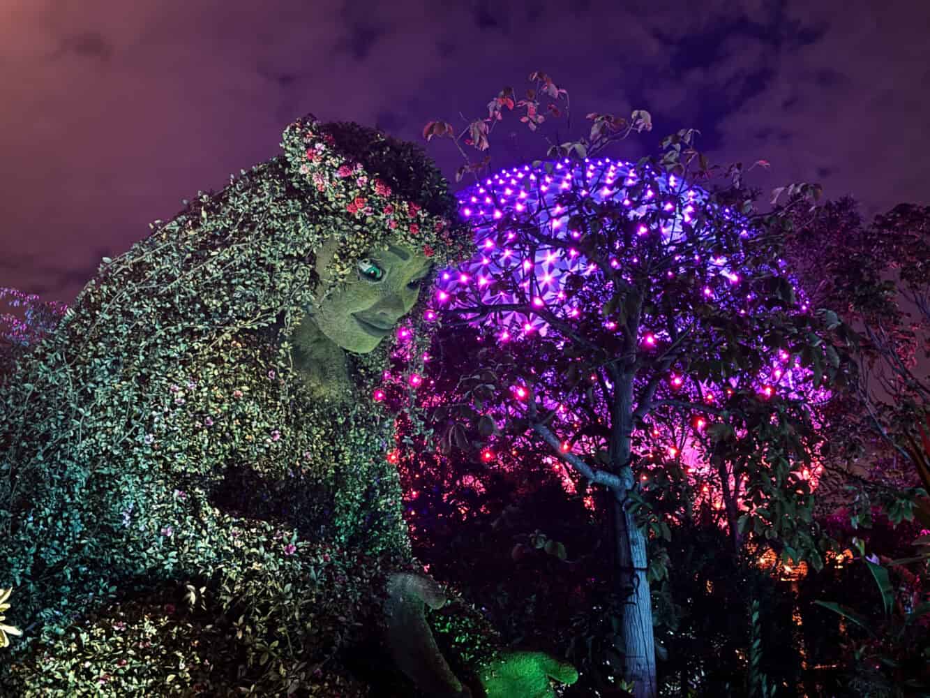 Te Fiti figure and Spaceship Earth at night in Journey of Water Moana attraction at Epcot, Disney World