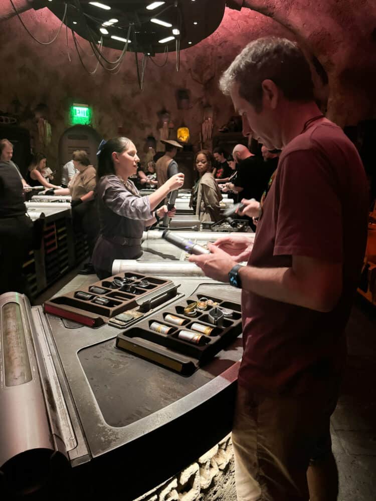 Simon making a lightsaber at Savi's Workshop in Disney's Hollywood Studios