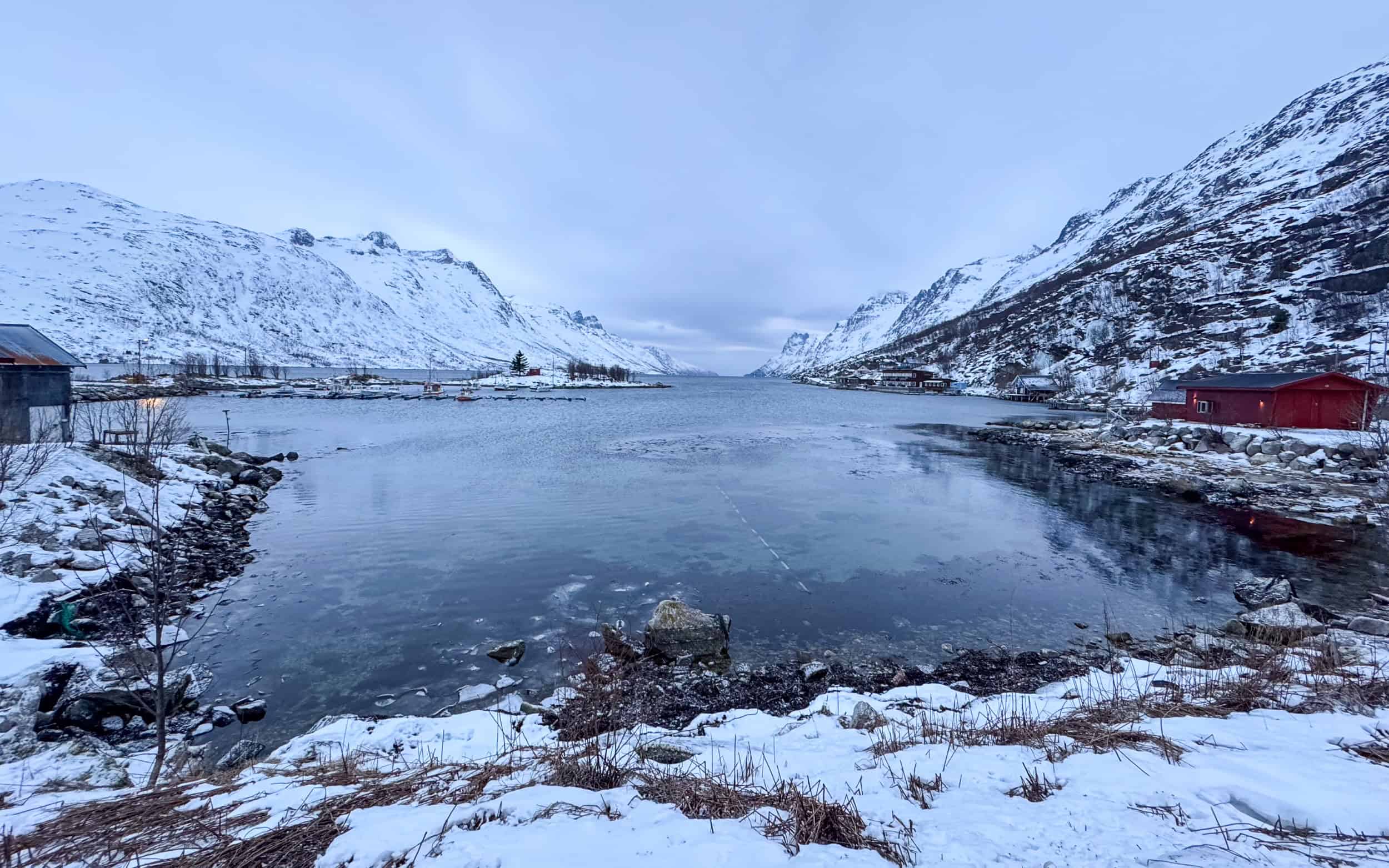 Snowy Ersfjordbotn village and fjord in Kvaloya Island, near Tromso, Norway.