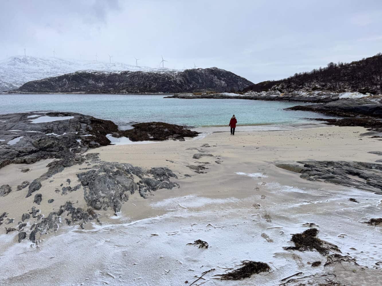 Walking on a snowy beach on Sommaroy Island in winter in Norway