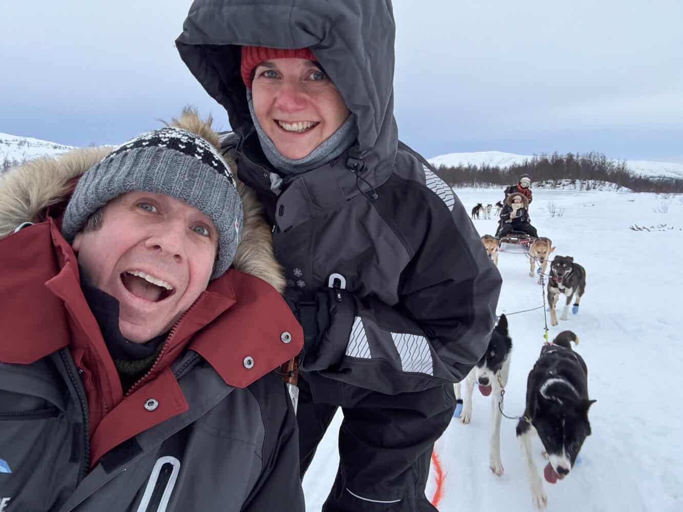 Simon and Erin husky dog sledding in Tromso, Norway